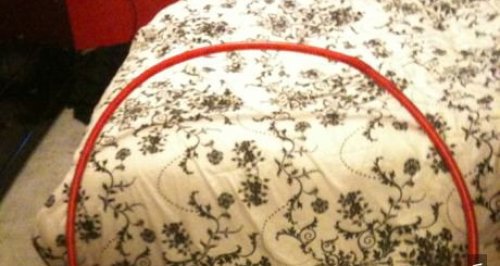 Can You Find It? This Photo Of A Red Ring On A Bed